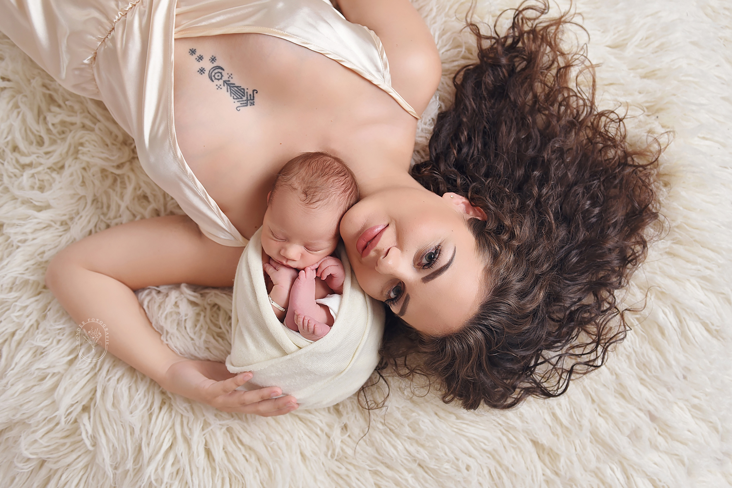 Newborn fotoshoot met zachte materialen en neutrale tinten in Flevoland